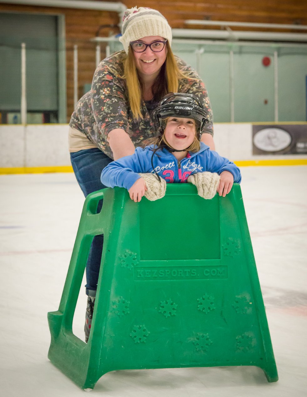 Toddler with parent on ice skates